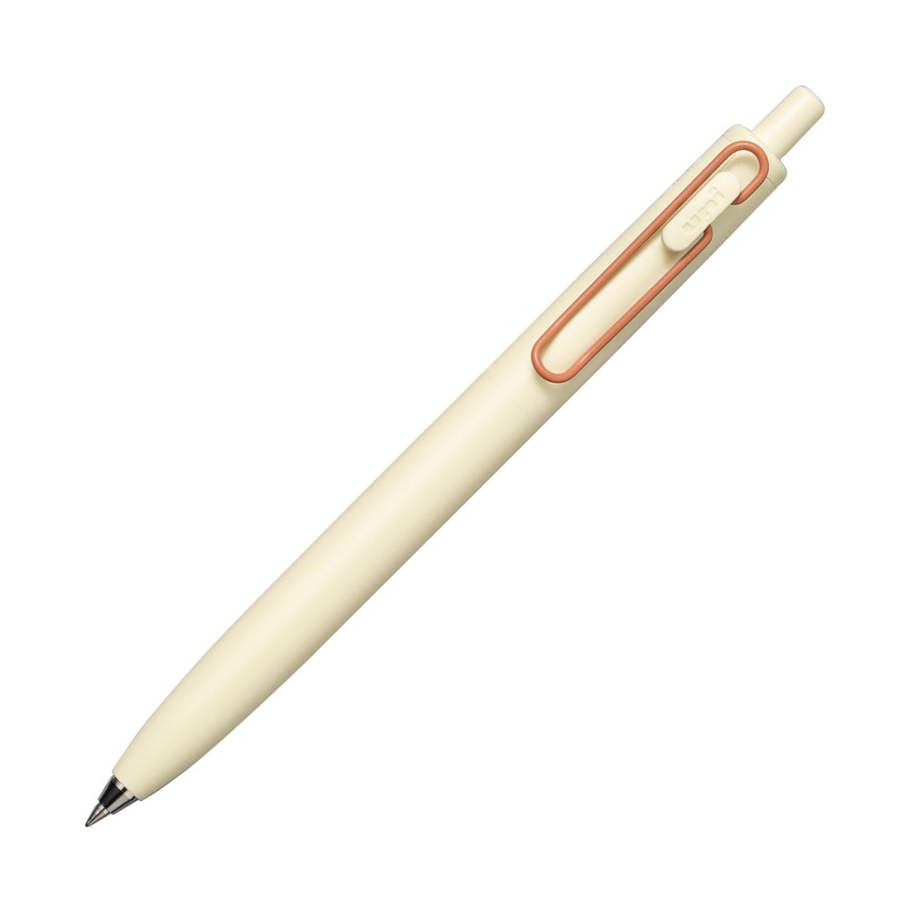 Cream Uni-ball One F pen with a copper clip.