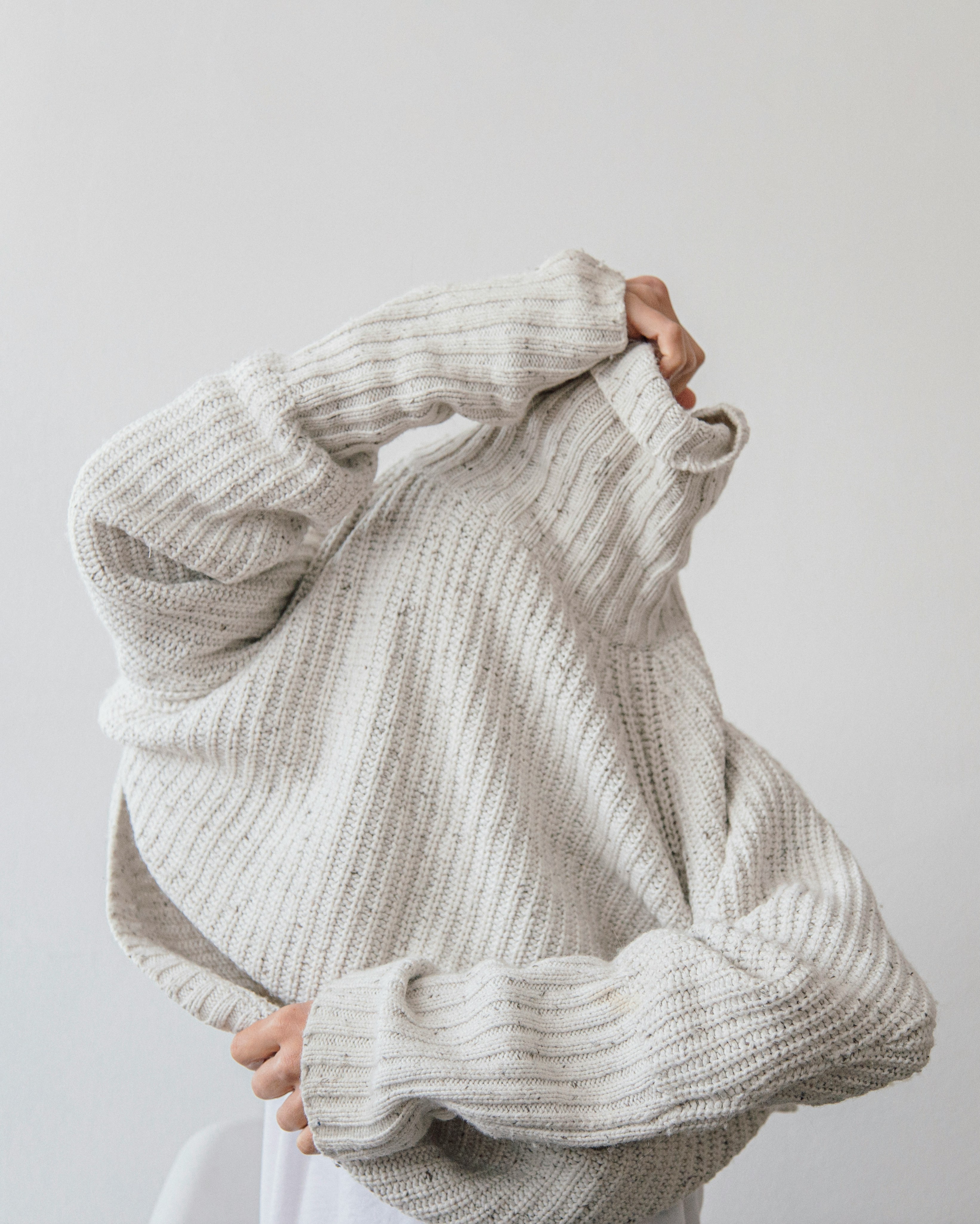 Man in gray sweater.